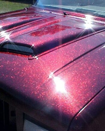 Rose Red Metal Flake paint on hood of Ford Explorer.