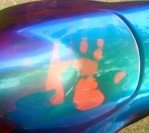 Temperature changing paint on Chameleon Super-Bike. John Haro's handprint on his thermochromic pigment painted motorcycle tank. Temperature changing chameleon!.