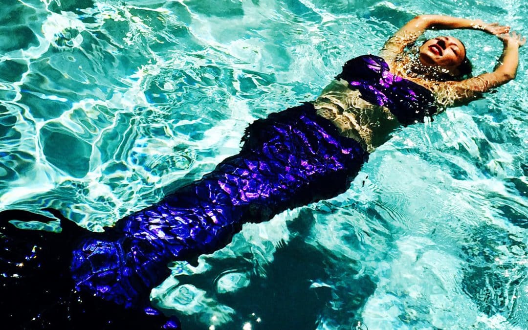 Mermaid Athena with her thermochromatic mermaid tail. This iridescent mermaid tail changes color in water.