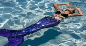 Silicone mermaid tail modeled in swimming pool.